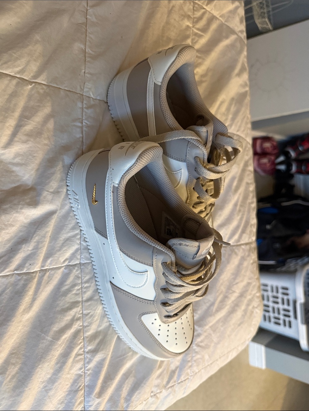 Nike woman’s AF1s Sneakers in White and Light Gray with Gold Swoosh